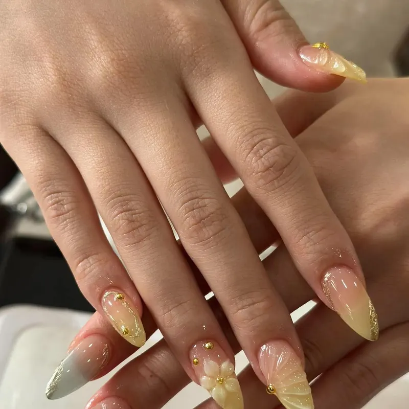 LENA Nails & Beauty Da Nang — Almond Nails with Gold Glitter Ombre & Flower Charm